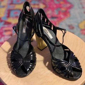 Melissa Peep-toe black and gold high heels.